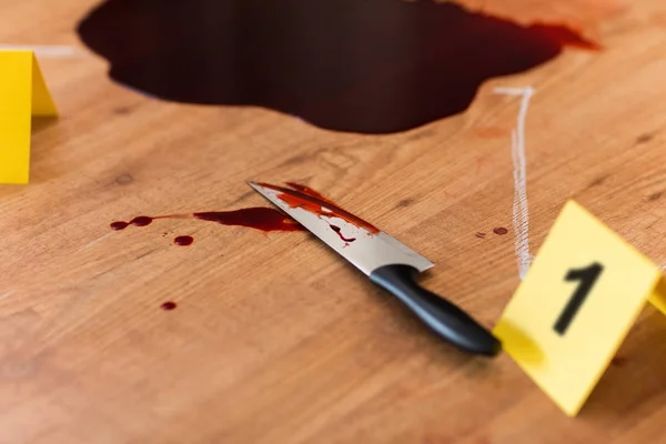 Knife in blood and chalk outline at crime scene — Stock Photo, Image