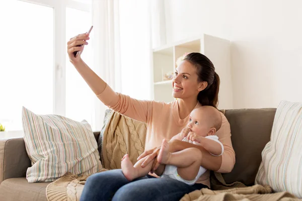 Glückliche Mutter mit Baby, das Selfie zu Hause macht — Stockfoto