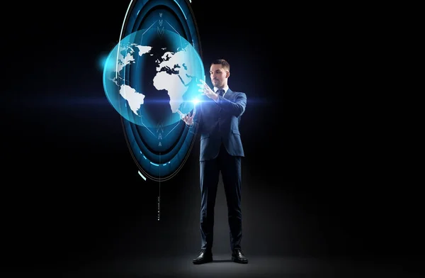 Businessman with earth hologram over black — Stock Photo, Image