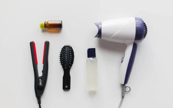 Hairdryer, brush, hot styling hair spray and iron — Stock Photo, Image