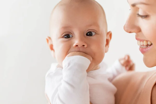 Feliz madre con pequeño bebé chico chupando dedos —  Fotos de Stock