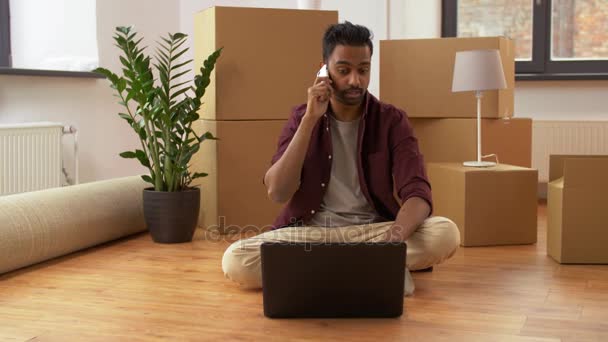 Homme avec ordinateur portable et boîtes appelant au téléphone à la maison — Video