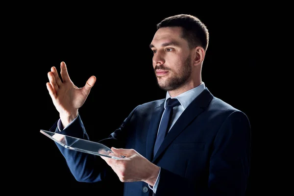 Businessman in suit working with transparent tablet pc — Stock Photo, Image