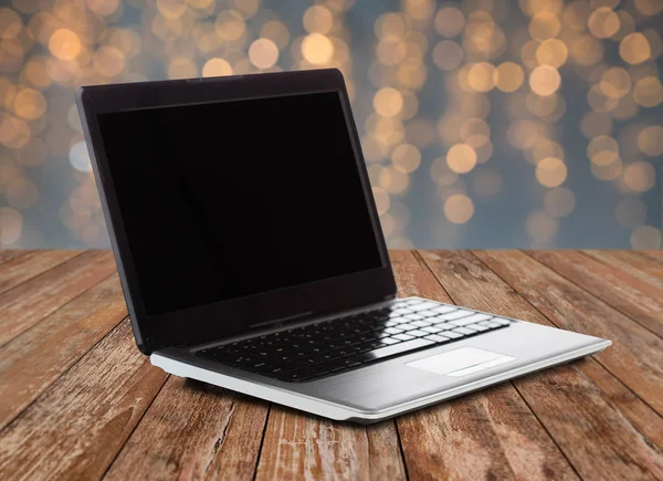 Laptop with blank black screen over lights — Stock Photo, Image