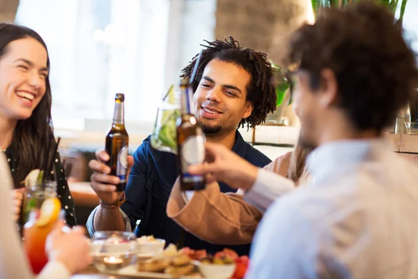 Happy friends drinking non alcoholic beer at bar — Stock Photo, Image