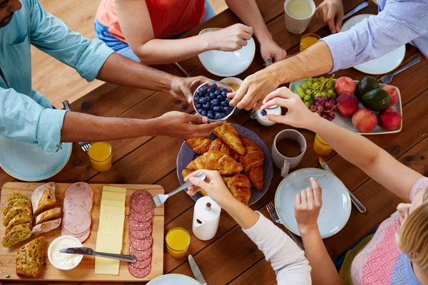 Group of people having breakfast at table — Stock Photo, Image