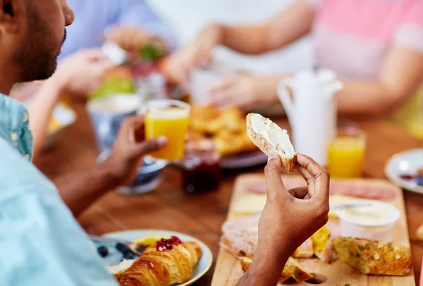 Close up of man eating toast with cream cheese — Stock Photo, Image