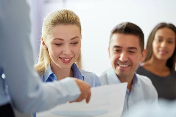 Group of smiling businesspeople at office — Stock Photo, Image