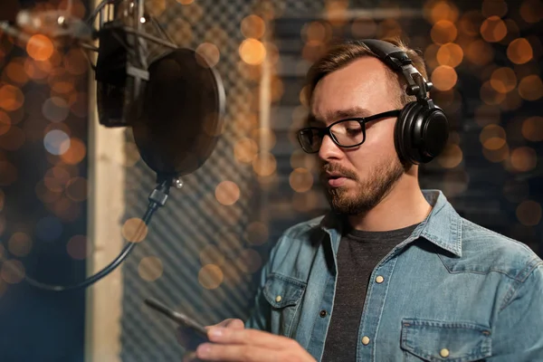 Singer with headphones at music recording studio — Stock Photo, Image