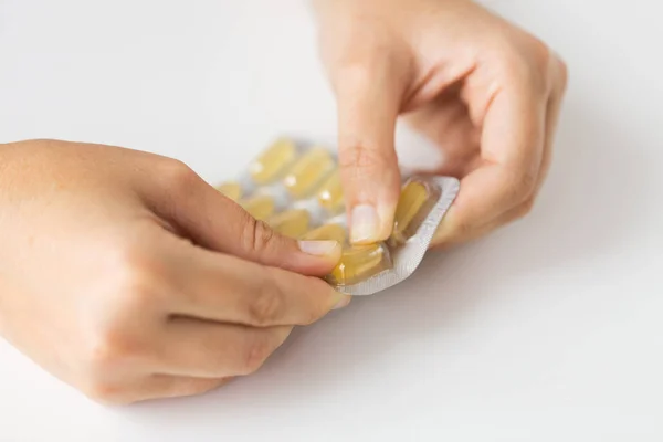 Mulher mãos embalagem de abertura de cápsulas de medicamento — Fotografia de Stock