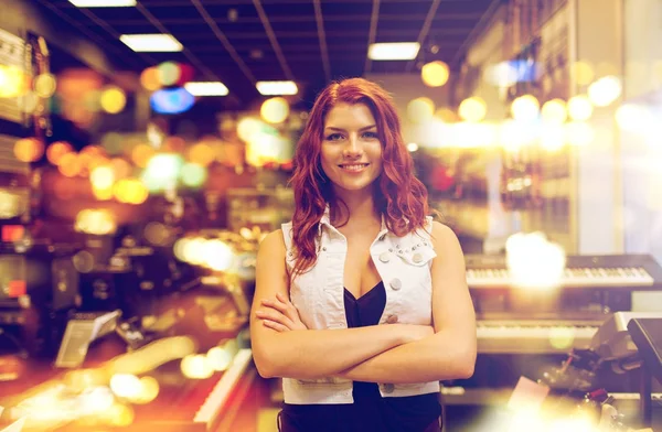 Smiling assistant or customer at music store — Stock Photo, Image