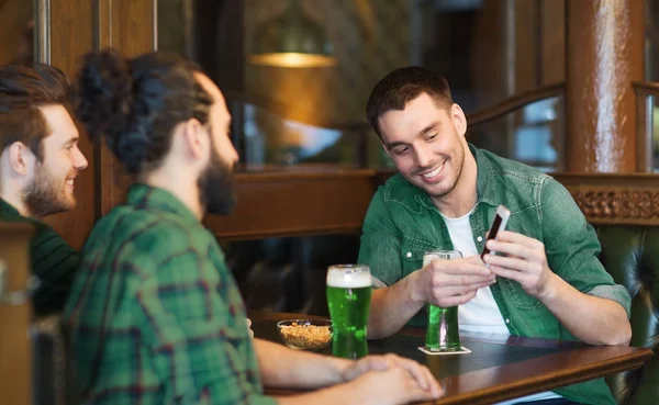 Παρέα με ένα smartphone, πίνοντας πράσινο μπύρα σε παμπ — Φωτογραφία Αρχείου