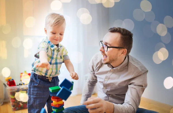 Far och son leker med leksak block hemma — Stockfoto