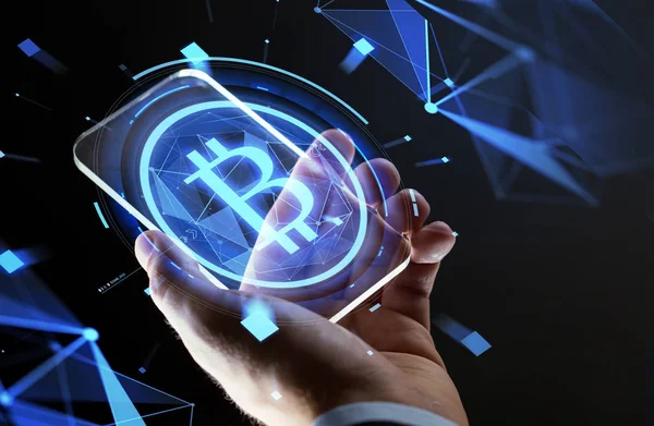 Close up of hand with smartphone and bitcoin — Stock Photo, Image