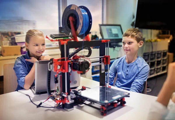 happy children with 3d printer at robotics school