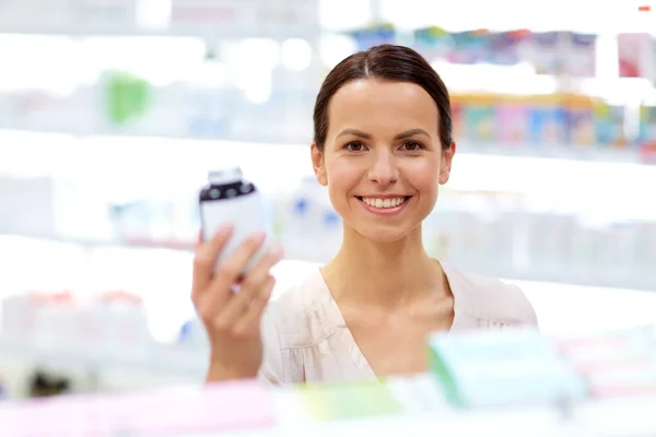 Female customer choosing drugs at pharmacy — Stock Photo, Image