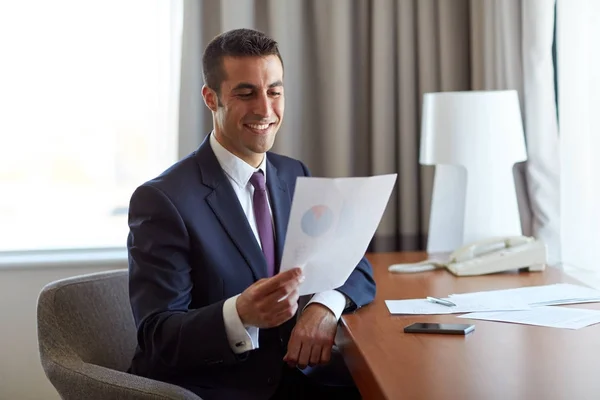 Businessman with papers working at hotel room — Stock Photo, Image