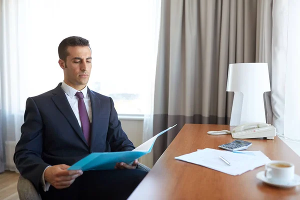 Businessman with papers working at hotel room — Stock Photo, Image