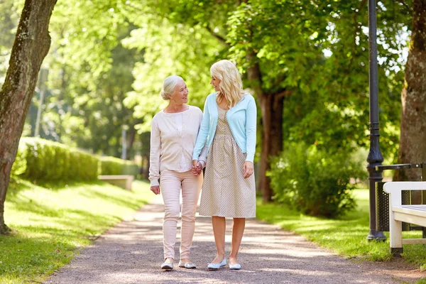 Dotter med senior mamma promenader på sommaren park — Stockfoto