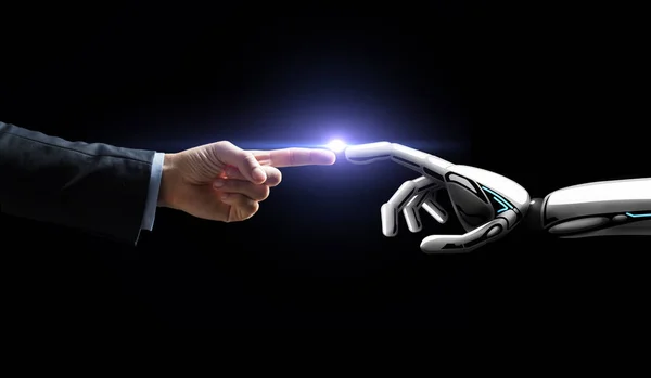 Robot and human hand flash light over black — Stock Photo, Image