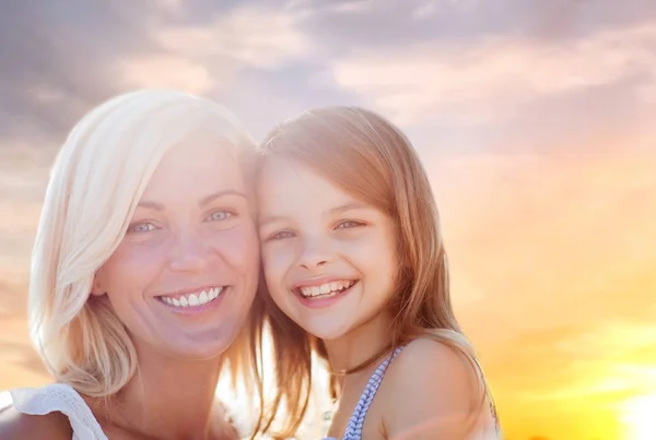 Happy mother and daughter portrait over summer sky — Stock Photo, Image