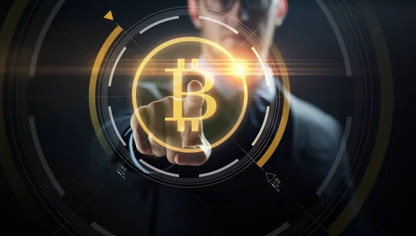 Close up of businessman with bitcoin hologram — Stock Photo, Image