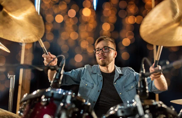 Musician playing drum kit at concert over lights — Stock Photo, Image