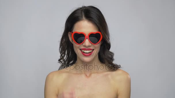 Woman with red lipstick and heart shaped shades — Stock Video