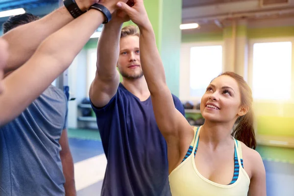 Group of happy friends making high five in gym Royalty Free Stock Photos