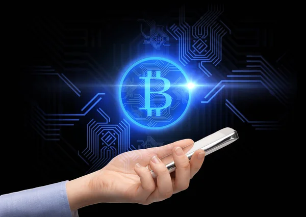 Close up of hand with smartphone and bitcoin — Stock Photo, Image
