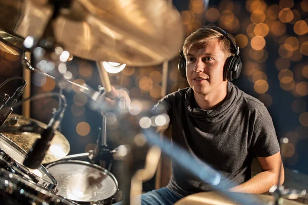 Musician playing drum kit at concert over lights — Stock Photo, Image