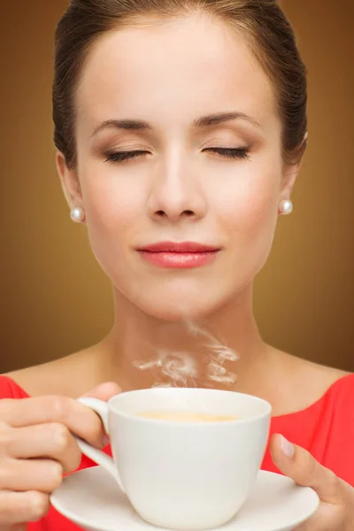 Bela mulher em vestido vermelho com xícara de café — Fotografia de Stock