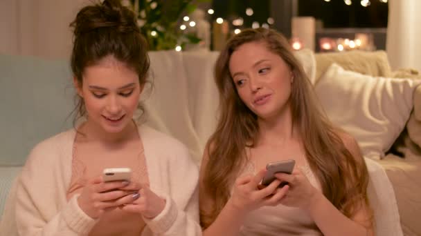 Щасливі друзі-жінки зі смартфонами вдома — стокове відео