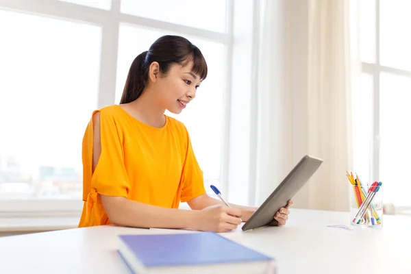 Asian student girl with tablet pc learning at home — Stock Photo, Image
