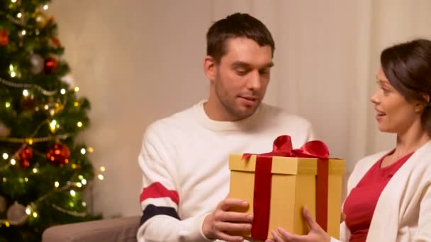 Счастливая пара с рождественским подарком дома — стоковое видео