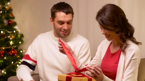 Ευτυχισμένο ζευγάρι με χριστουγεννιάτικο δώρο στο σπίτι — Αρχείο Βίντεο