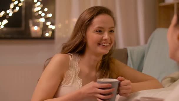 Woman drinking tea and talking to friend at home — Stock Video