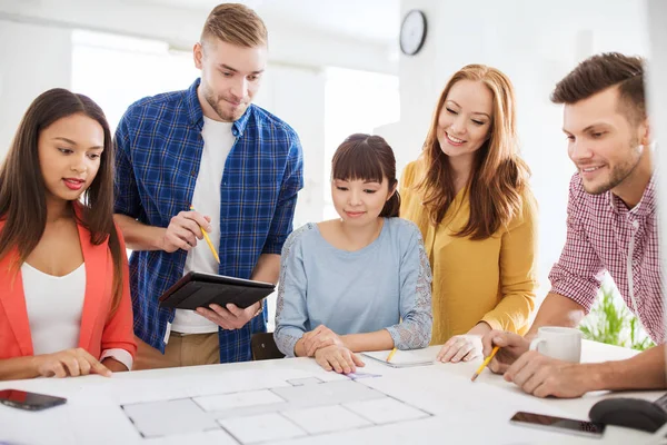 Creative team with blueprint working at office — Stock Photo, Image