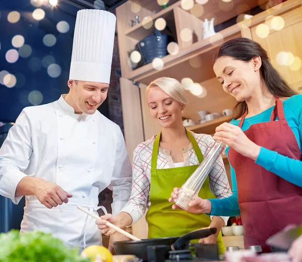 Gelukkig vrouwen en chef kok koken in de keuken — Stockfoto