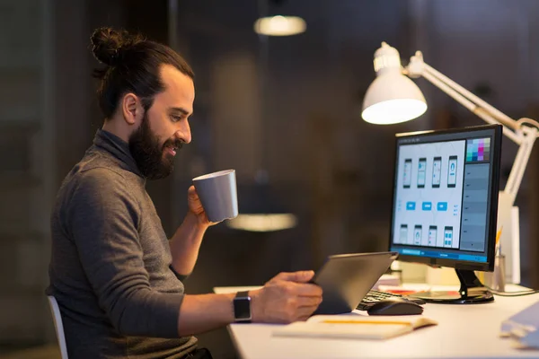Creative man with computer working late at office — Stock Photo, Image