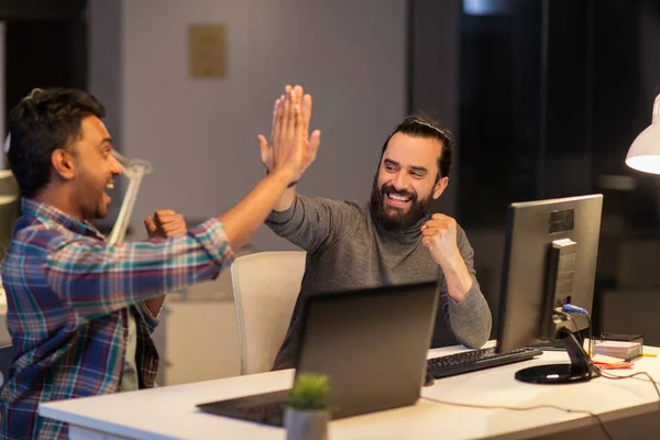 Kreativteam macht High Five im Nachtbüro — Stockfoto