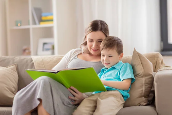 Glückliche Familie liest Buch zu Hause — Stockfoto