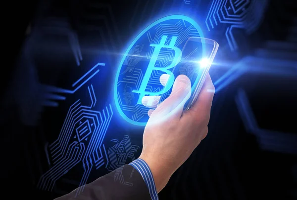 Close up of hand with smartphone and bitcoin — Stock Photo, Image