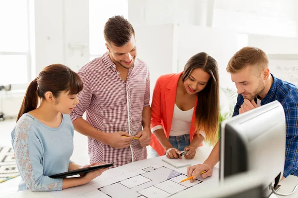 Creative team with blueprint working at office — Stock Photo, Image