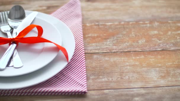 皿の上の赤いリボンで結ばれたカトラリー — ストック動画