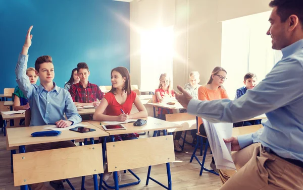 Group of students and teacher with papers or tests — Stock Photo, Image