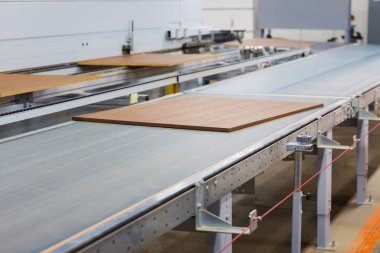 chipboards on conveyer at furniture factory clipart