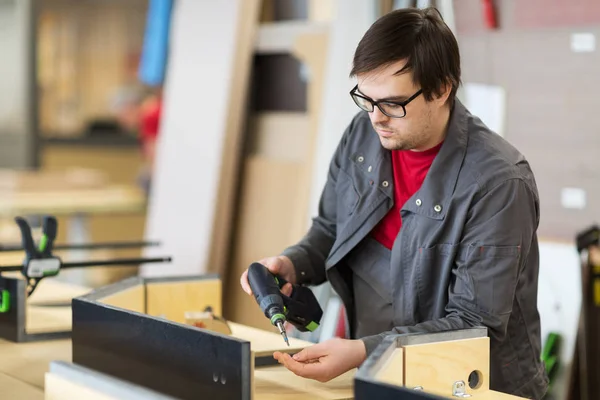 Assembler with screwdriver making furniture — Stock Photo, Image