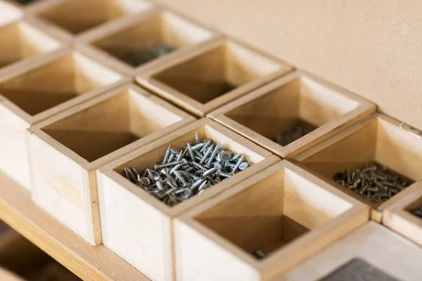 Screws in wooden boxes at workshop — Stock Photo, Image