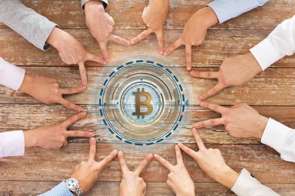 Business team showing peace hand sign with bitcoin — Stock Photo, Image